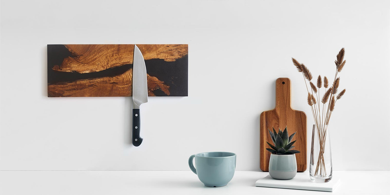 salvaged live edge acacia wood and black epoxy river magnetic knife rack holding a kitchen knife