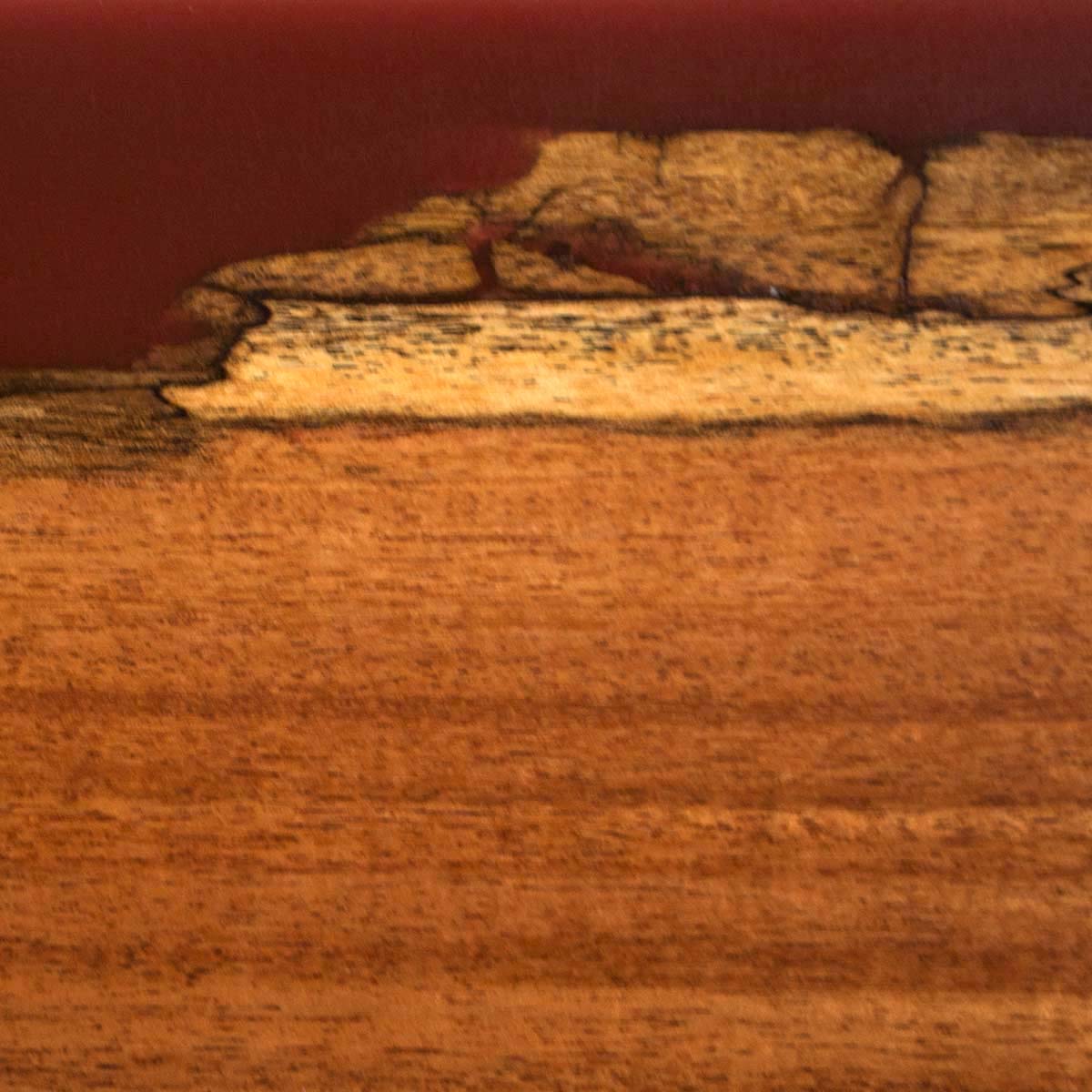 Live edge Sweet Acacia wood with burgundy red epoxy, a detailed close up photo of a magnetic knife holder to show the detail in the live edge and the wood grain