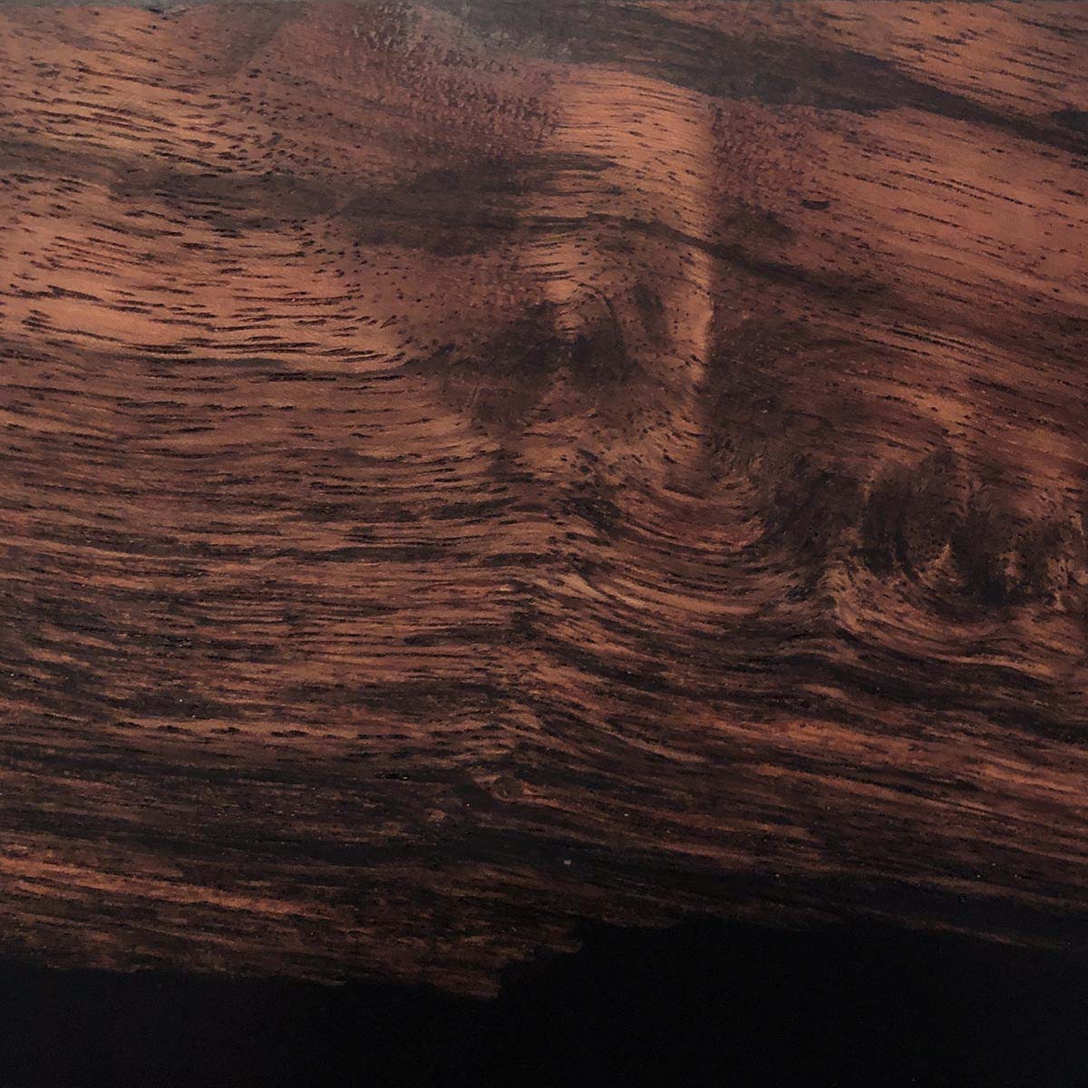 Tamarind wood with black epoxy, a detailed close up shot to show the live edge and wood grain detail