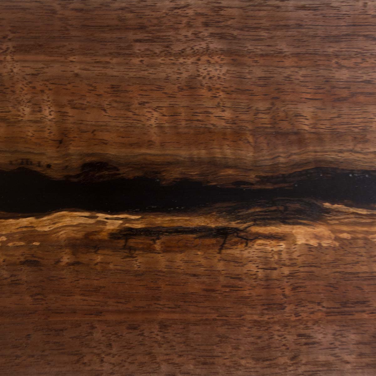 close up detail of walnut wood grain and black epoxy resin