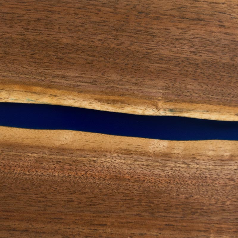 detailed close up view of black walnut live edge wood grain and blue epoxy resin