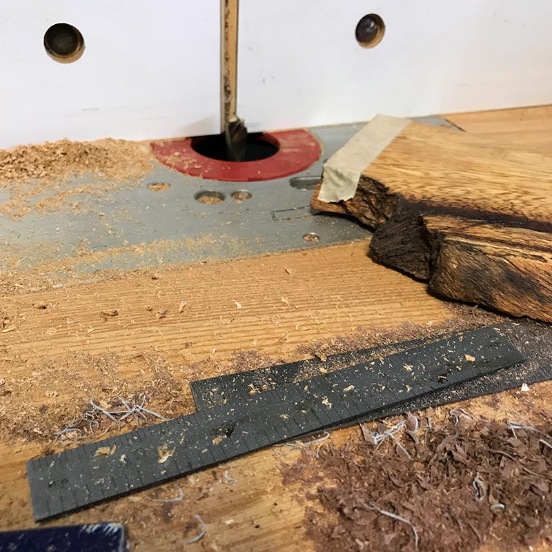 making a salvaged albizia wood knife holder on a router table by creating channels for hidden magnets