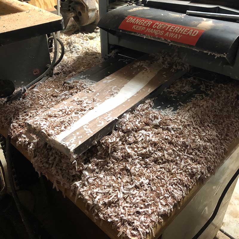 using a benchtop planer to flatten and plane an epoxy river magnetic knife holder and creating wood chips and plastic epoxy shavings