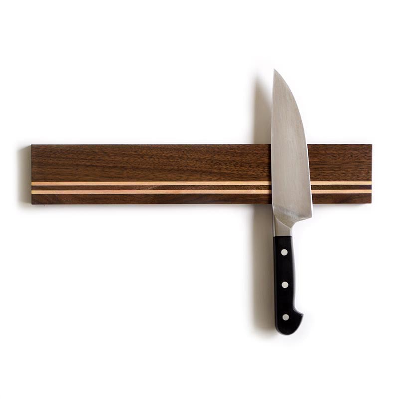 real walnut magnetic knife holder with maple stripes holding a chefs knife