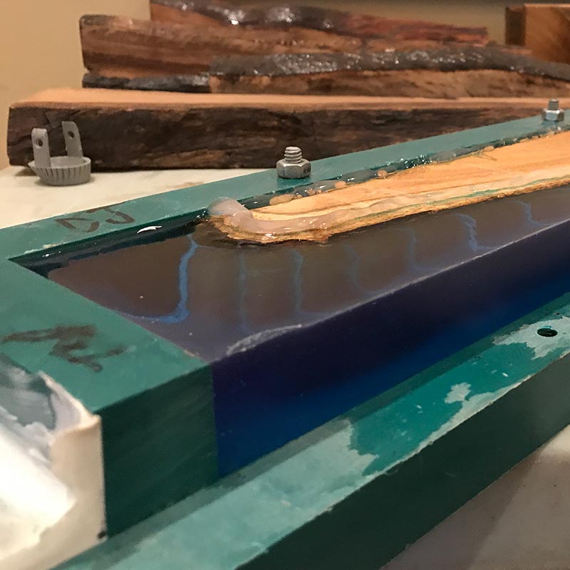 removing an epoxy resin and salvaged wood knife holder from a mold after the resin has cured