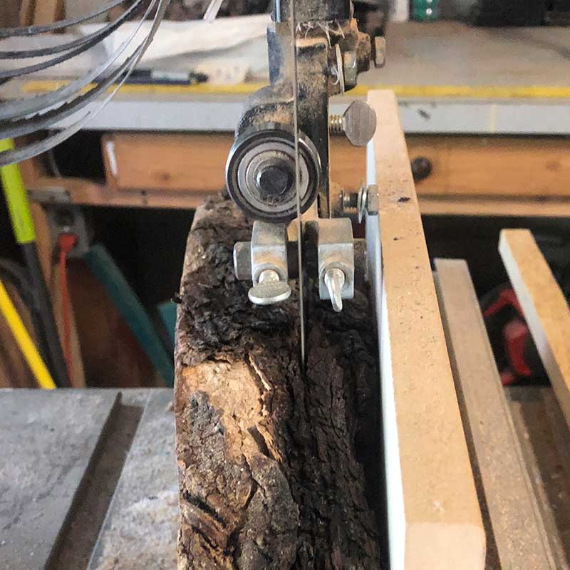 using a bandsaw to resaw a piece of live edge acacia wood to make an epoxy river magnetic knife holder