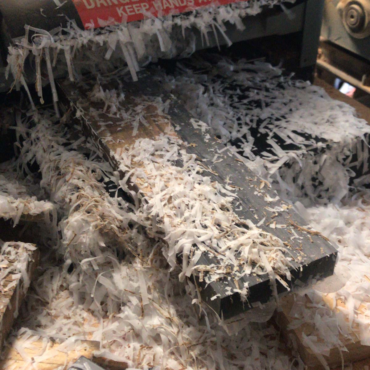 plastic epoxy resin shavings on a planer after running a magnetic knife holder through it