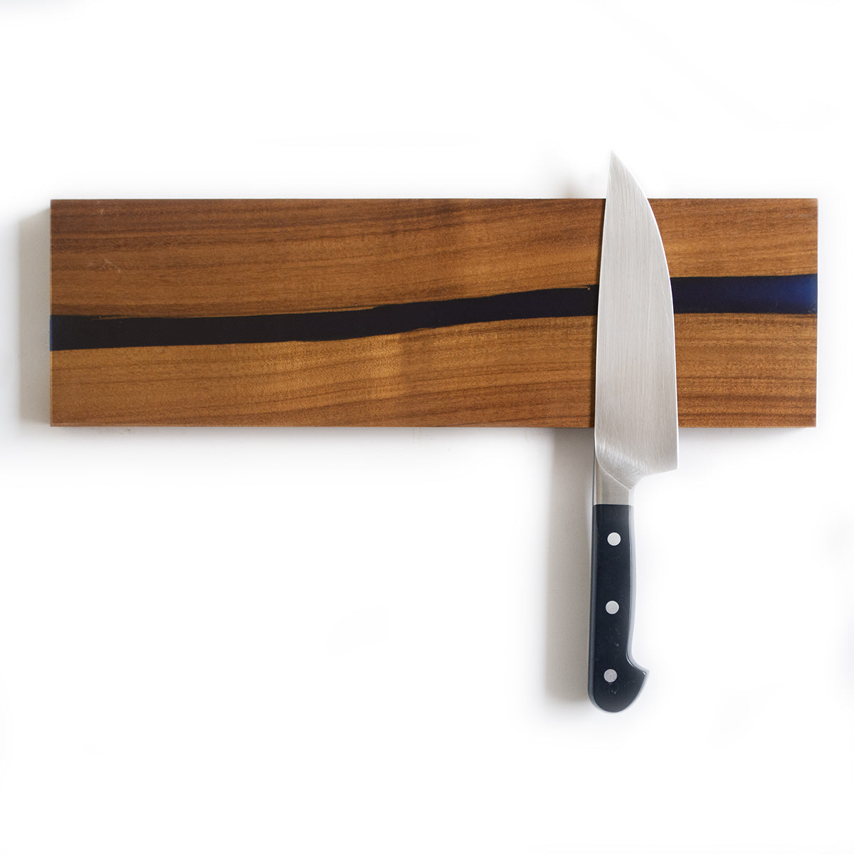 magnetic knife holder made with sweet acacia hardwood and an epoxy resin river, holding a chefs knife