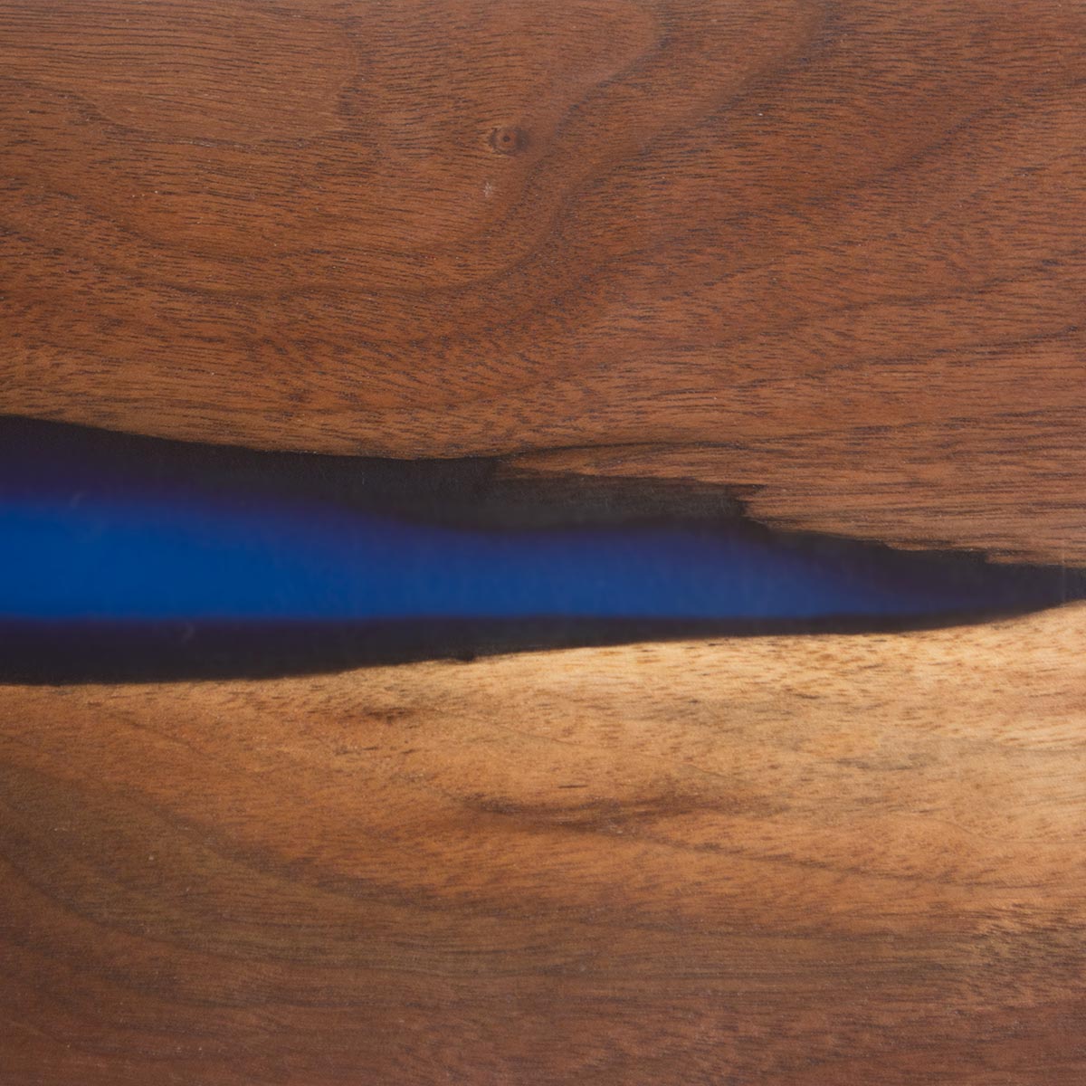 walnut wood grain close up view of a magnetic knife holder made with epoxy resin and live edge wood