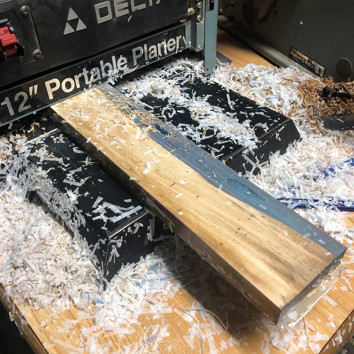 florida acacia life edge wood and epoxy resin magnetic knife holder being planed with a benchtop planer